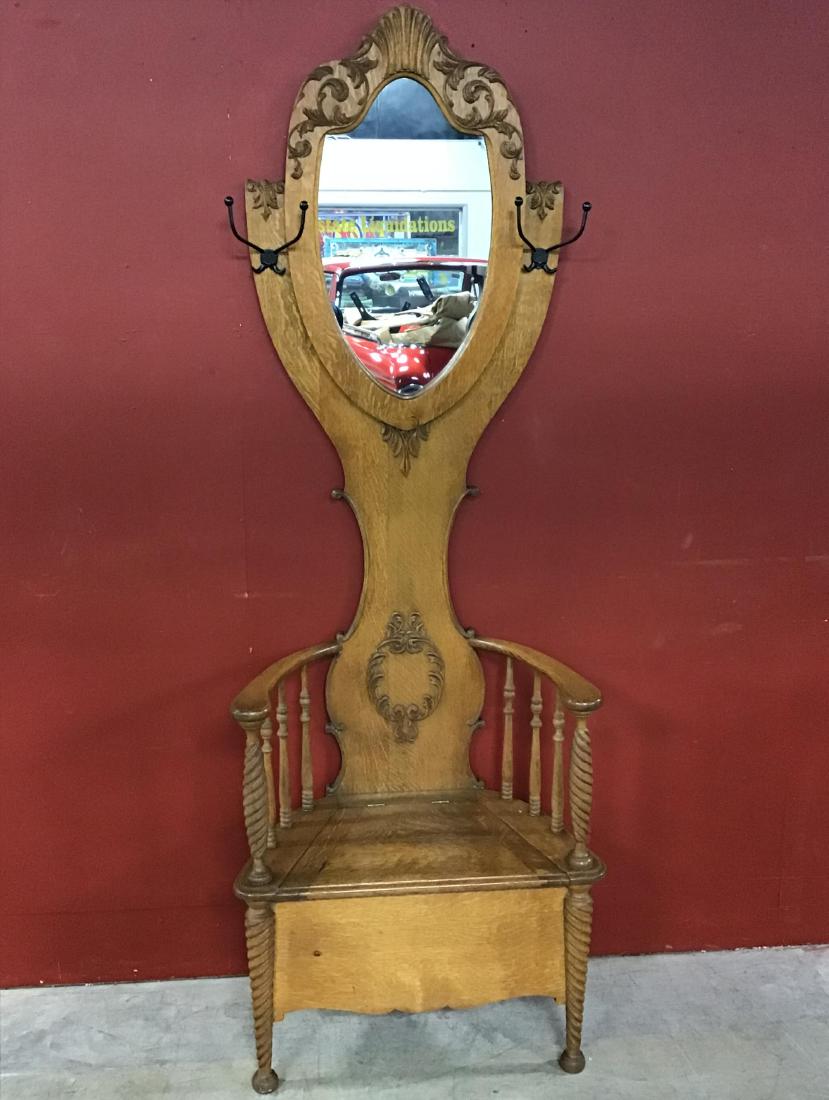 Tiger Oak Petite Hall Tree: Very decorative applied carvines twisted legs, completely refinished, mirror has been replaced. Storage under seat, VG condition. 82 Inches T x 27.75 Inches W x 16 Inches D.
