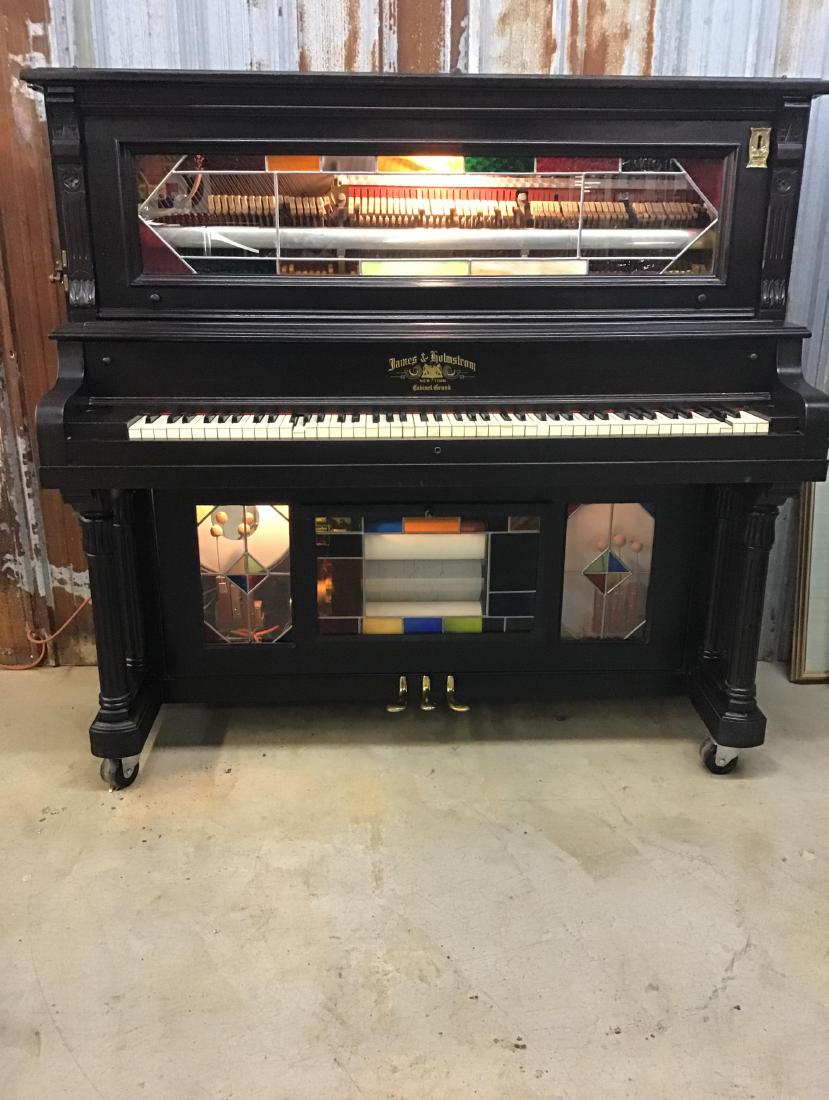 James and Holmstrom Nickelodeon Player Piano: Has good sound, plays, operable condition. Will need tuning/ Beautiful stained glass windows, mahogany case. 64 Inches W x 58 Inches T x 27.75 Inches D.