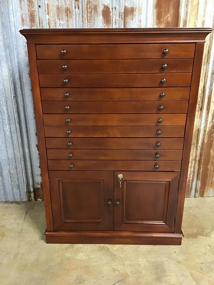 9 Drawer Humidor: This humidor has a cherry finish, drawers holding 216 cigars, has locking 2 door storage, has key, working order. VG condition. 34.75 Inches W x 50.5 Inches T by 17 Inches D.