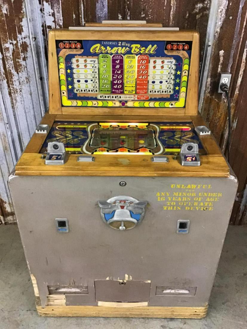 Rare! Universals 2 Way Arrow Bell 5 Cent Slot Machine: Working order will need some bulbs replaced. Has key to machine but not to cash box. 1930s to 1940s. Does have some veneer damage on front as seen in pictures. Found condition. 36 Inches W x 24 Inch D