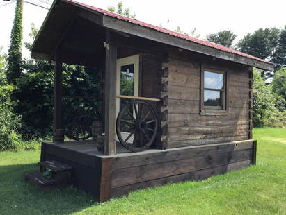 Log Cabin: Handcrafted with metal roof, very sturdy, Inside dimensions are 7 FT x 11 FT, Outside 8FT 8 Inches x 16 FT 7 Inches. Built on trailer, can easily be moved. Wagon wheel porch railings, would make great