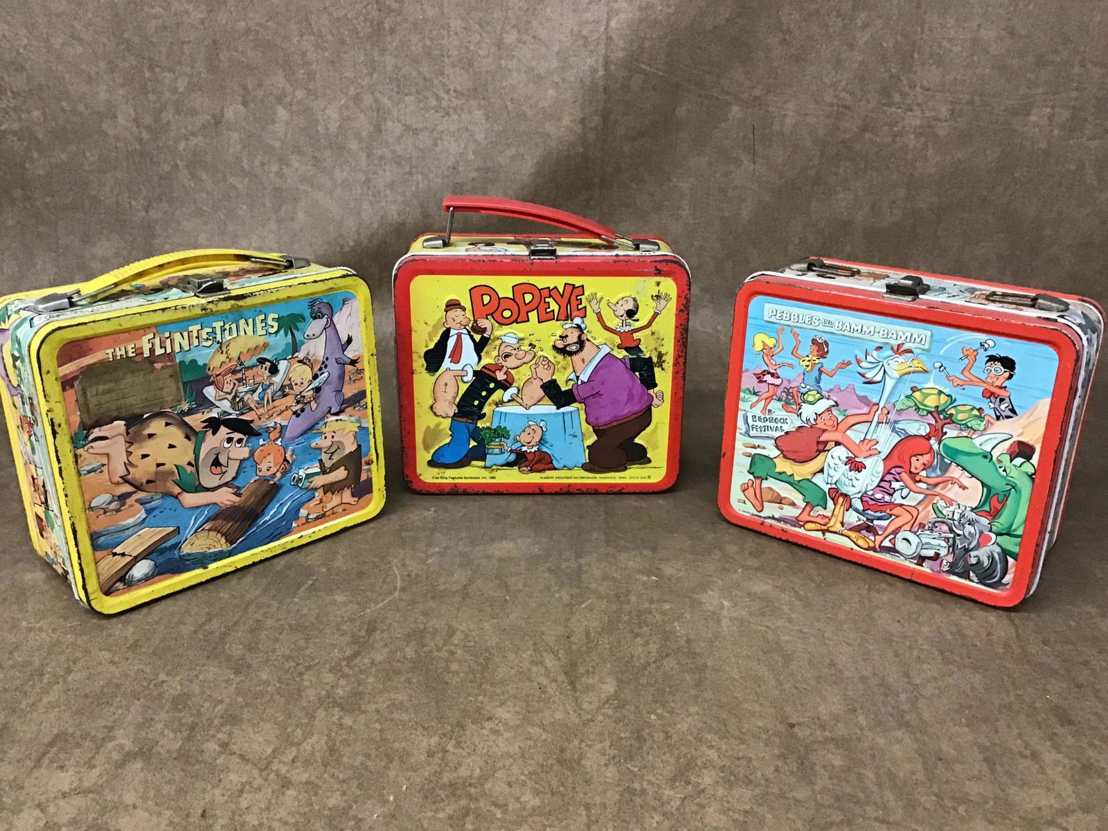 Lot of 3 Vintage Lunch Boxes: Peebles and Bam Bam, no thermos, broken handle. 1980 Popeye, no thermos. The Flintstones, has thermos. Found condition.
