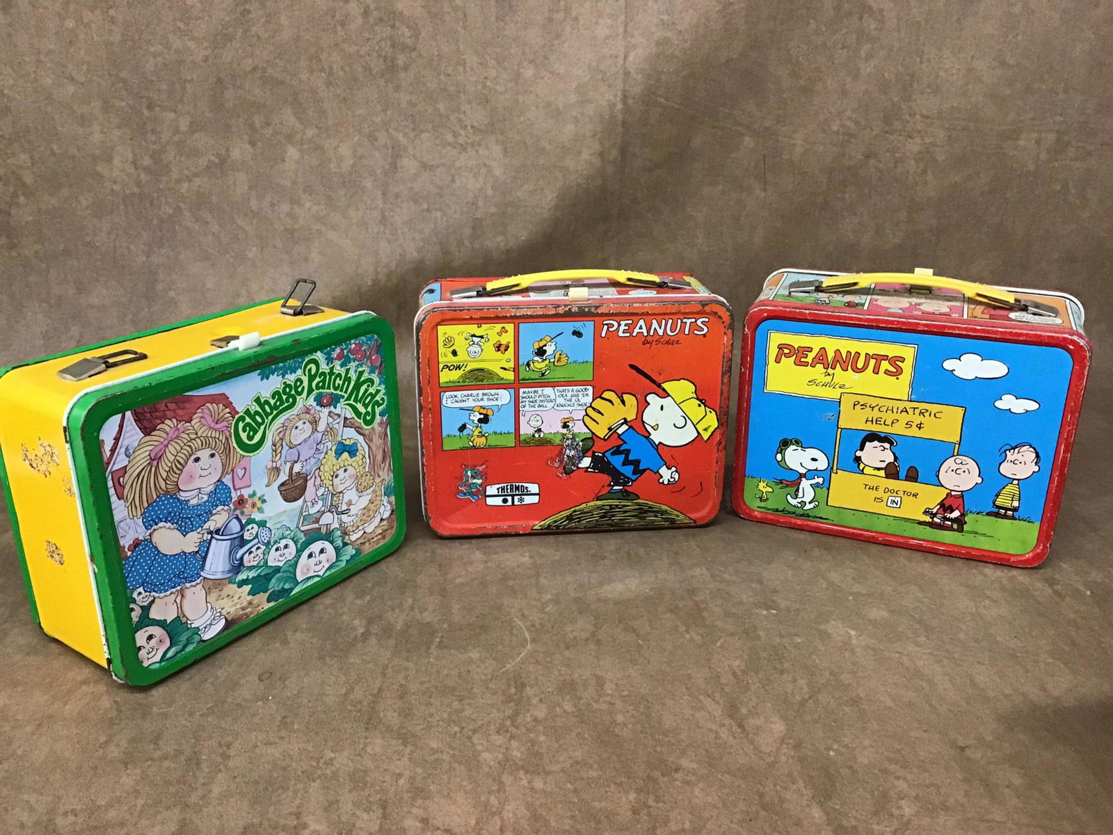 Lot of 3 Vintage Lunch Boxes: 2 Peanuts, one has thermos. Cabbage Patch Kids, has thermos, handle broken. Found condition