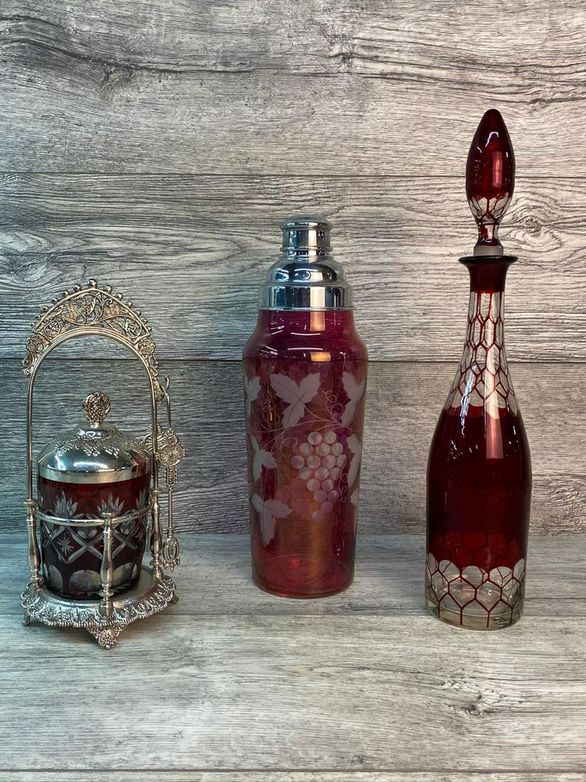 RUBY RED LOT: SHAKER-13", NO CHIPS, NO CRACKS. DECANTER-16", DECANTER TOPPER HAS CHIPS. PICKLE CASTER-11"T (IN STAND) VERY GOOD CONDITION.