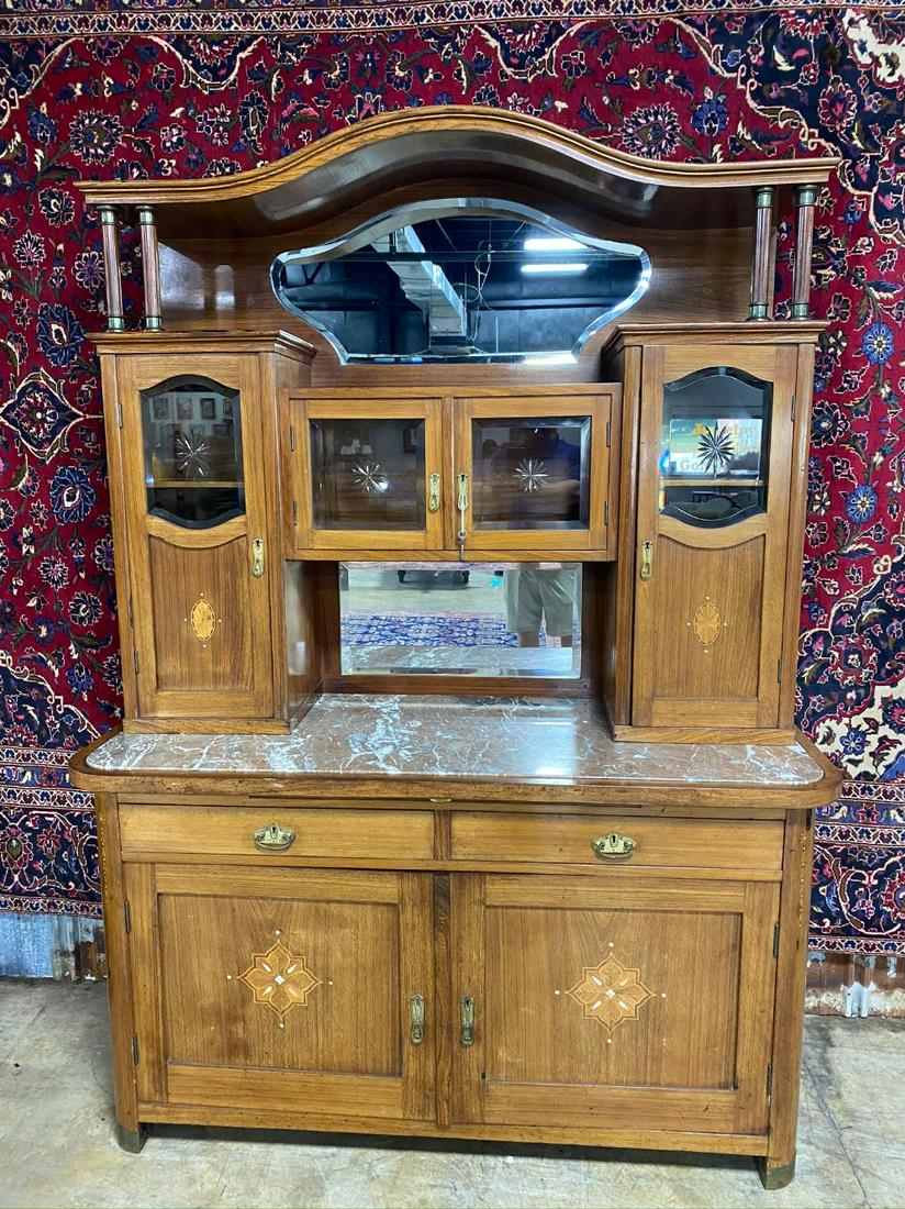 SUPERB MARBLE TOP SIDEBOARD/ BUFFET: CATHEDRAL TOP WITH DOUBLE BEVELED MIRROR. BELVELED CUT GLASS DOORS. MOTHER OF PEARL INLAY. ORIGINAL BRASS HARDWARE. DOVE TAILED CONSTRUCTION. VG FOUND CONDITION. WOULD MAKE AN EXCELLENT BAR. SLIDE OUT