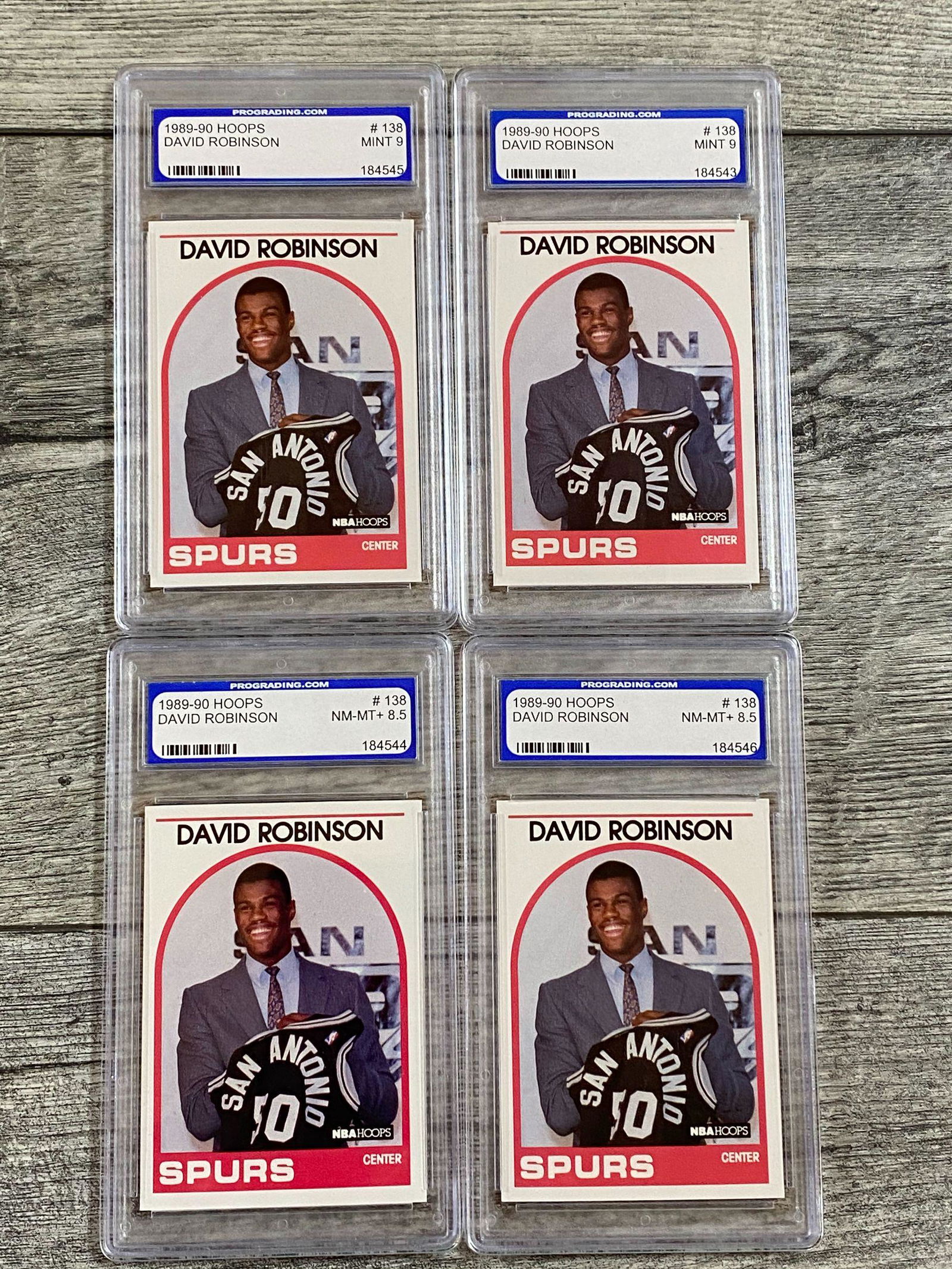 Lot of 4 1989-90 Hoops David Robinson RCs Graded: Two1989-90 Hoops #138, both NM-MT+ 8.5 and two at Mint 9 by Prograding.Com. SOLD AS IS. BUYER ASSUMES ALL RISKS AND RESPONSIBILITY, WE CANNOT GUARANTEE OR AUTHENTICATE