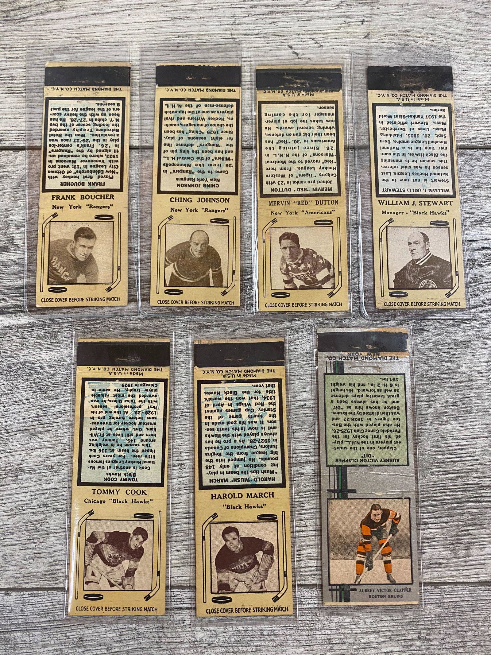 Lot of seven 1935-36 Diamond Match Cover Hockey Series: (not numbered): Harold March (Black Hawks),Aubrey Victor Clapper (Bruins), Ching Johnson (Rangers), William J. Stewart (Black Hawks), Mervin (Red) Dutton (Americans)Frank Boucher (Rangers), Tommy Cook