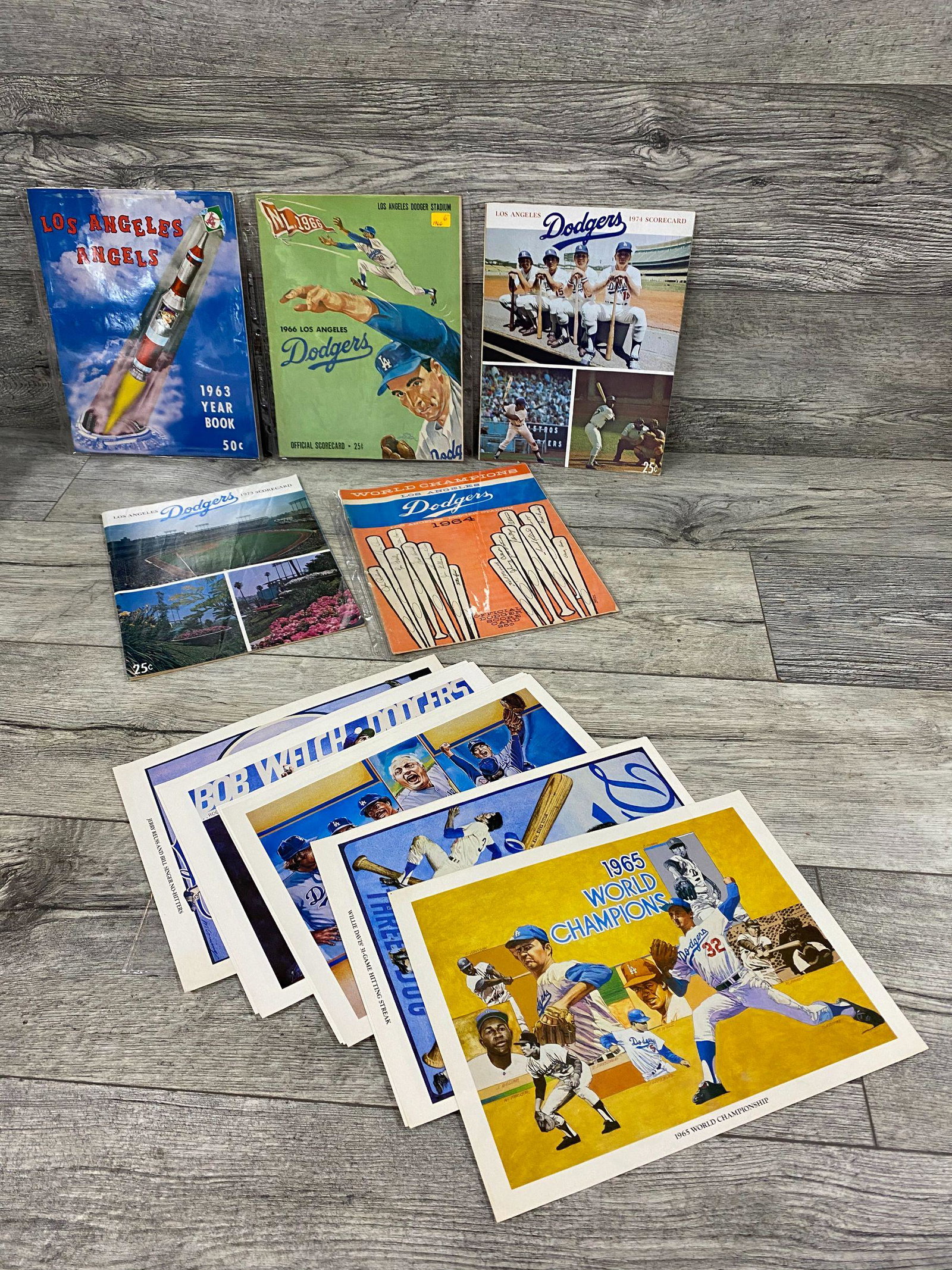 Four L.A. Dodger Programs and tribute prints: 1963 LA Dodgers Yearbook, 1964 Official Scorecard, LA Dodgers vs. Pittsburgh Pirates (no date), 1966 Official Scorecard, LA Dodgers vs. Atlanta Braves (Aaron HR), (no date), 1973 Official Scorecard (u