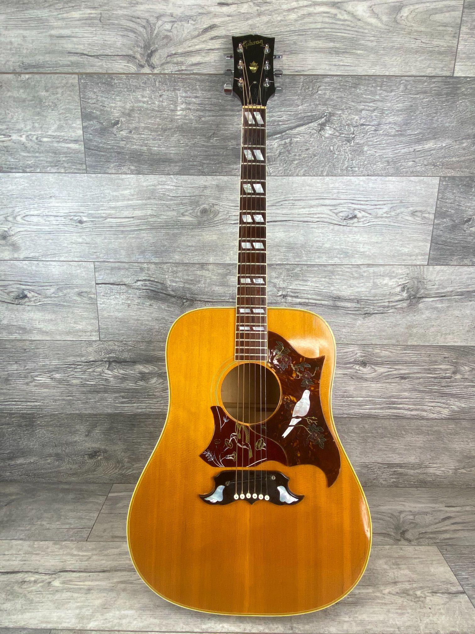 VINTAGE 1960'S GIBSON DOVE ACOUSTIC GUITAR: LATE 1960'S MAPLE GIBSON DOVE. HUMMINGBIRD PICK GUARD HAS BEEN ADDED. PICK GUARD HAS SOME RAISED AREAS-ONE PIECE HAS BEEN REPAIRED-AS NOTED IN PHOTOS. WITH HARD CASE.