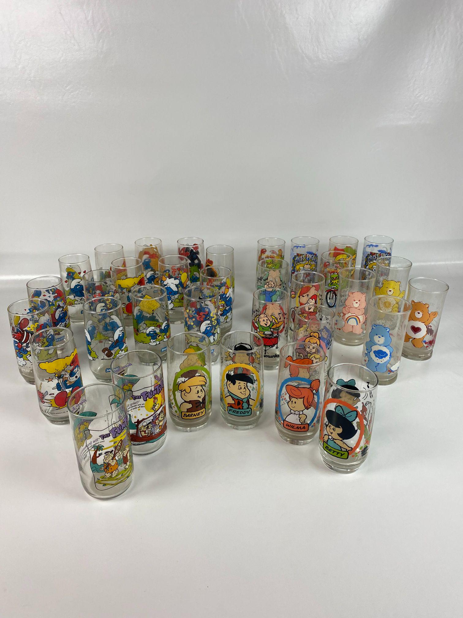 LOT OF 34 CARTOON COLLECTOR GLASSES: 15-SMURFS GLASSES, 5-MUPPETS, 4-CARE BEARS, 4-ALVIN AND THE CHIPMUNKS GLASSES, 6-FLINTSTONES GLASSES