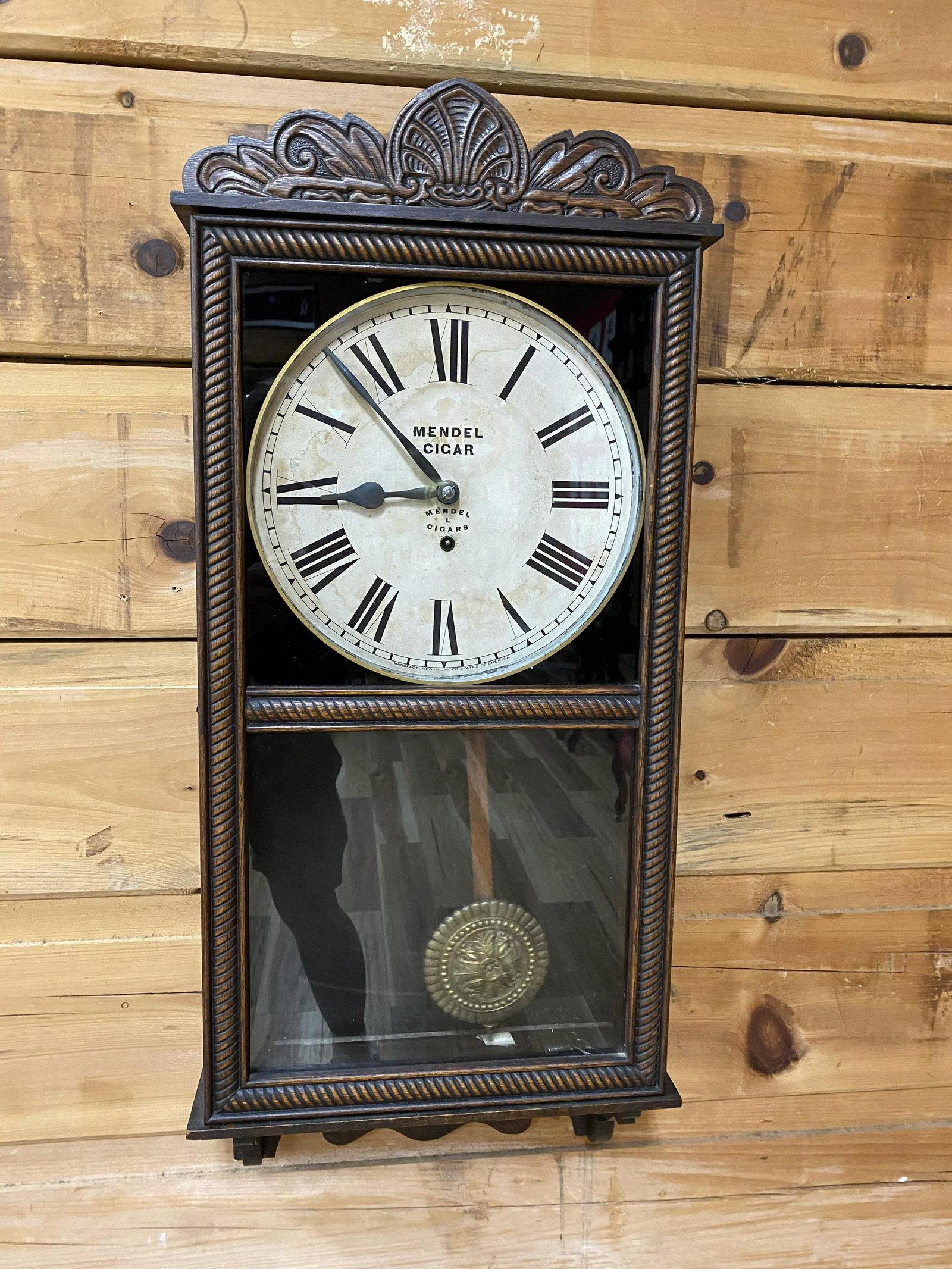 MENDEL CIGAR WALL CLOCK: SOLID OAK CASING, HAS KEY AND PENDULUM- CLOCK IS IN WORKING ORDER. *WE ADVISE CLOCKS BE SERVICED AFTER SHIPPING* 34IN T X 15-3/4IN