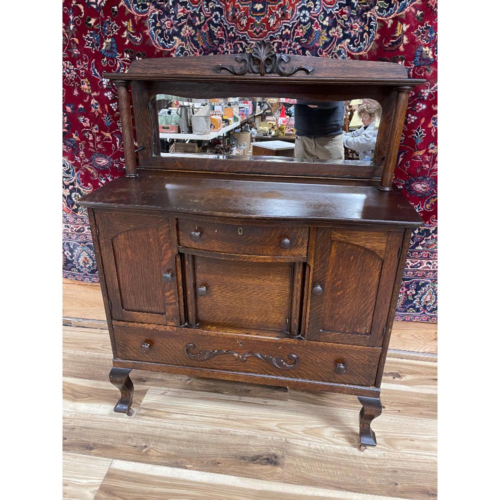 Petite Tiger Oak Sideboard/Buffet: Original finish, bevel mirror, applied carvings, estate found cond., 42in W x 56.5in T x 19.5 D.