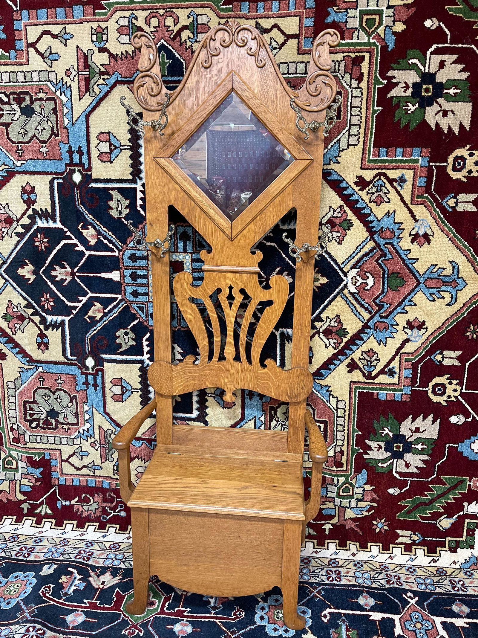 TIGER OAK HALL TREE: VERY DECORITIVE, BEVEL MIRROR, BRASS HOOKS. 28IN W x 76 1/2IN T