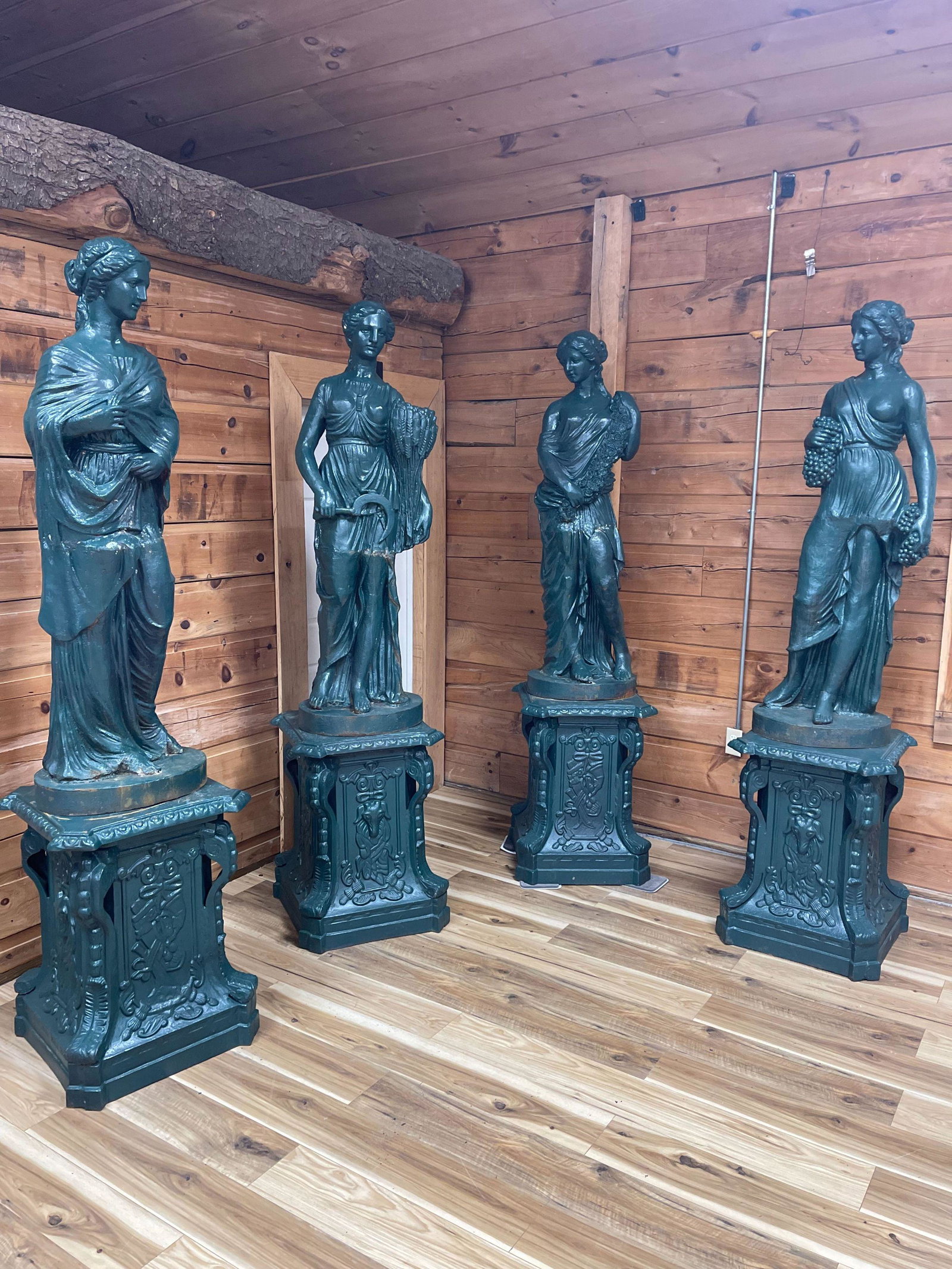 INCREDIBLE SET OF FOUR SEASONS CAST IRON STATUES ON PEDESTALS: RARE SET OF THE GODDESSES OF THE SEASONS IN CLASSIC BAROQUE STYLE. FIGURES STANDING ON MATCHING BASES. ALL CAST IRON. BASES: 24" X 24" X 31 1/2"T-95" TALL OVERALL, ESTATE FOUND CONDITION