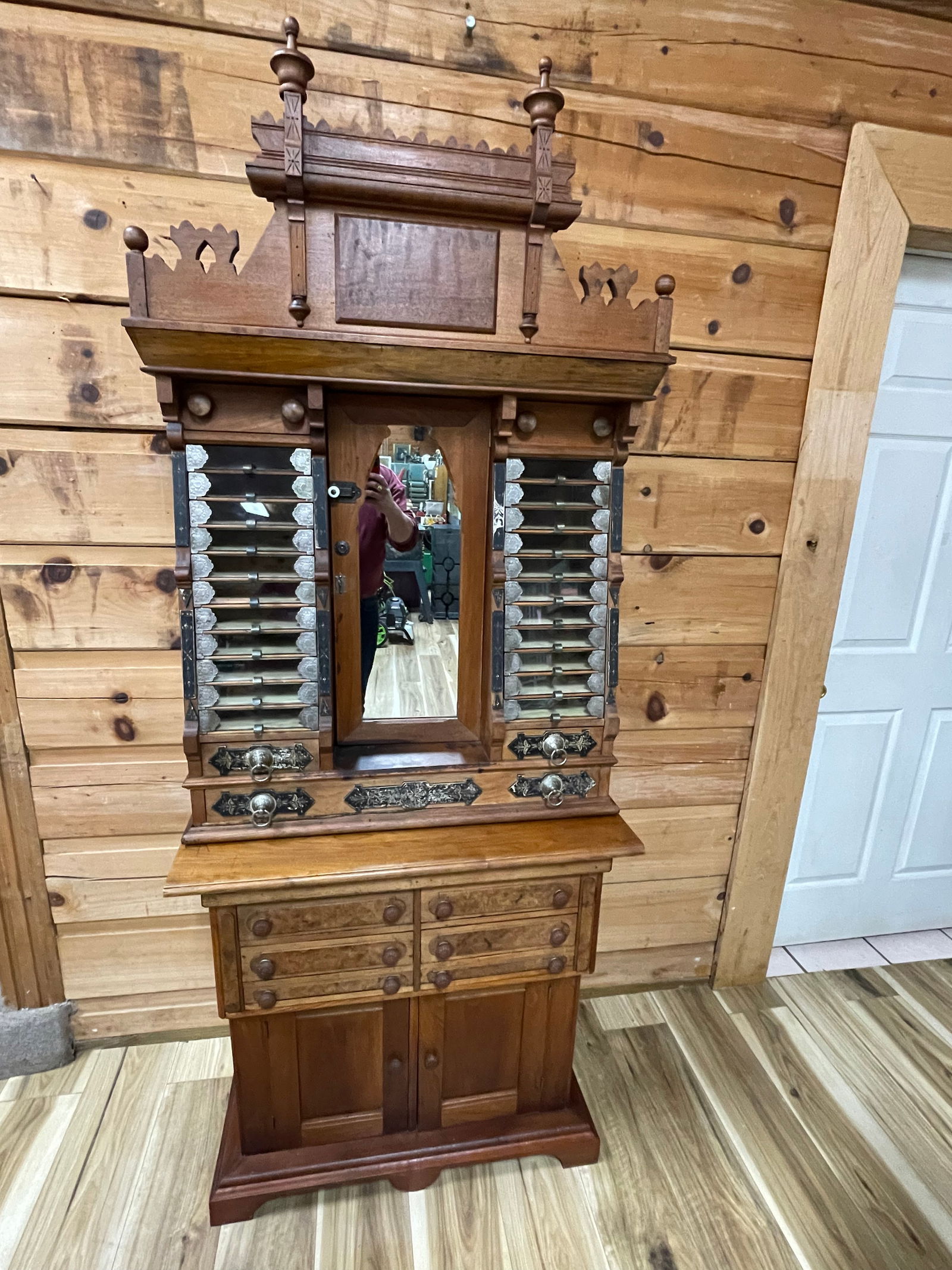 RARE FIND! BRAINERD AND ARMSTRONG SPOOL CABINET: CARVED WALNUT CABINET GALLERY CREST WITH TURNED FINIALS, 11 GLASS FRONT DRAWERS ON EACH SIDE, SITTING ON VICTORIAN BURL WALNUT BASE. 82.75"T X 33.25"W X 18.25"D.