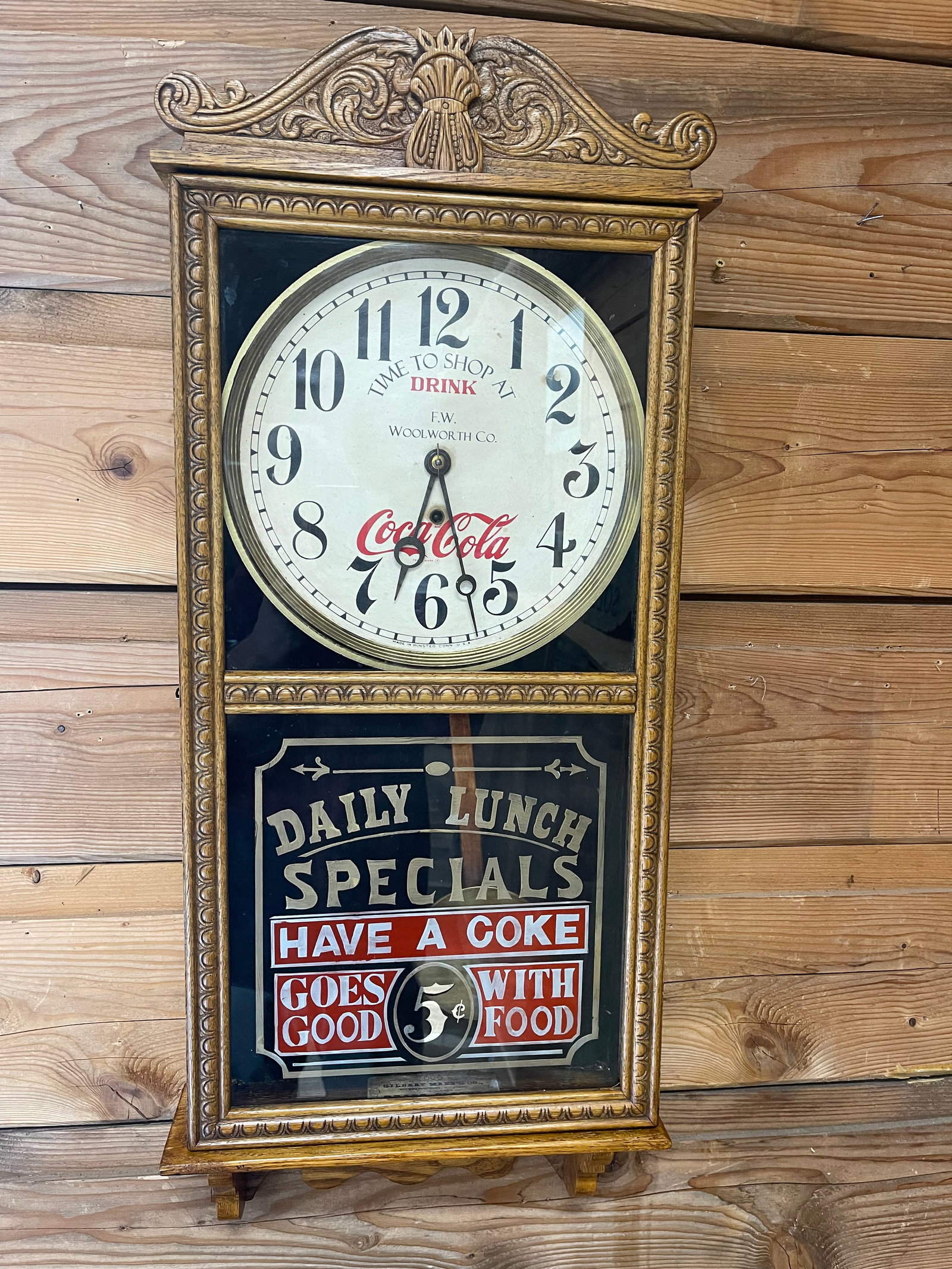 ORIGINAL GILBERT OAK COCA-COLA ADVERTISING CLOCK: COCA-COLA ADVERTISEMENT AS WELL AS WOOLWORTH COMPANY. GLASS ADVERTISEMENT HAS BEEN RECONDITIONED. THE WOOD HAS BEEN COMPLETELY REFINISHED AS WELL. IN WORKING ORDER. 36"T X 15.5"W.