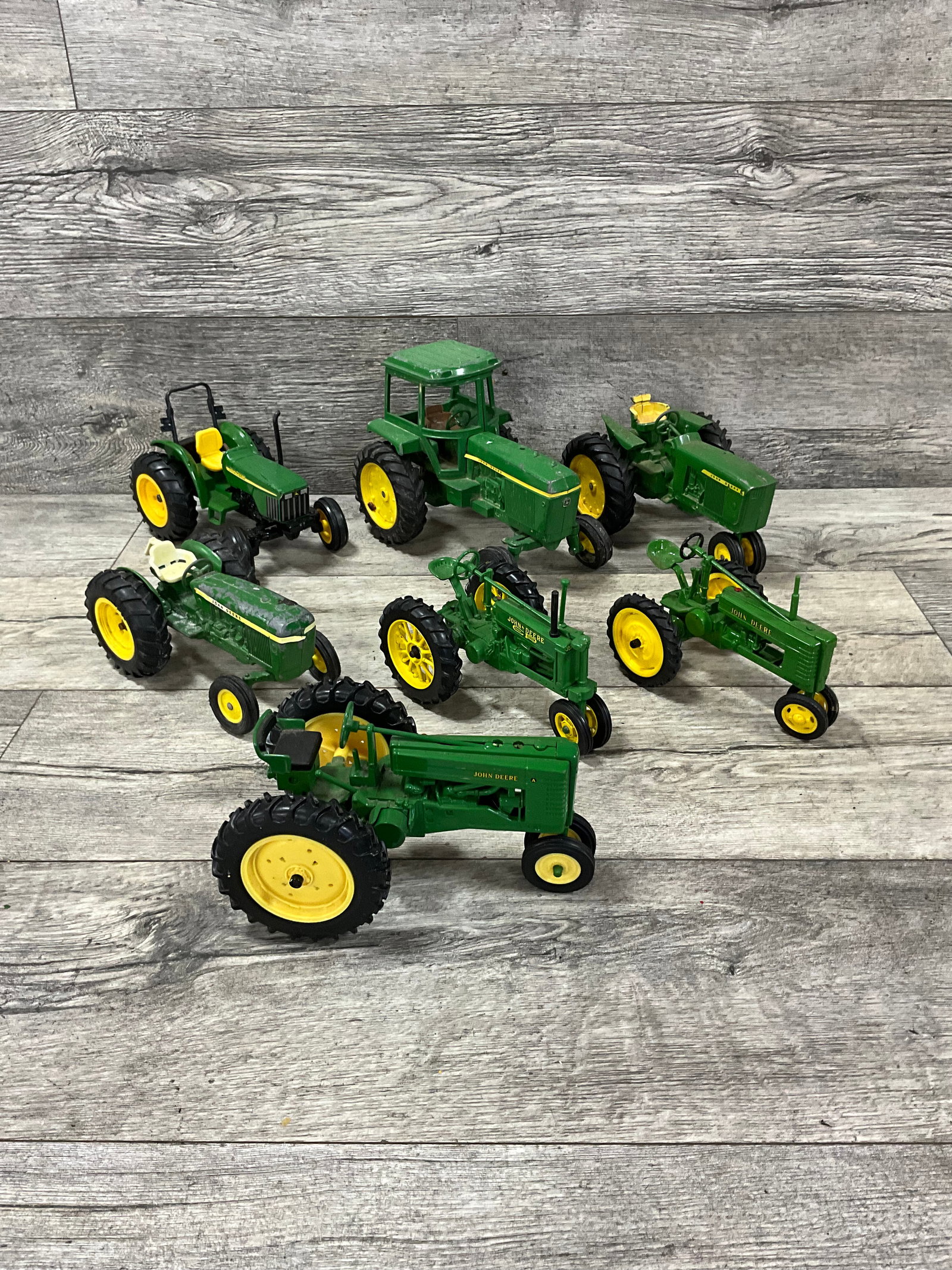 LOT OF 7 DIE CAST JOHN DEERE TRACTORS: FOUND CONDITION. ERTL AND OTHER MFGS.