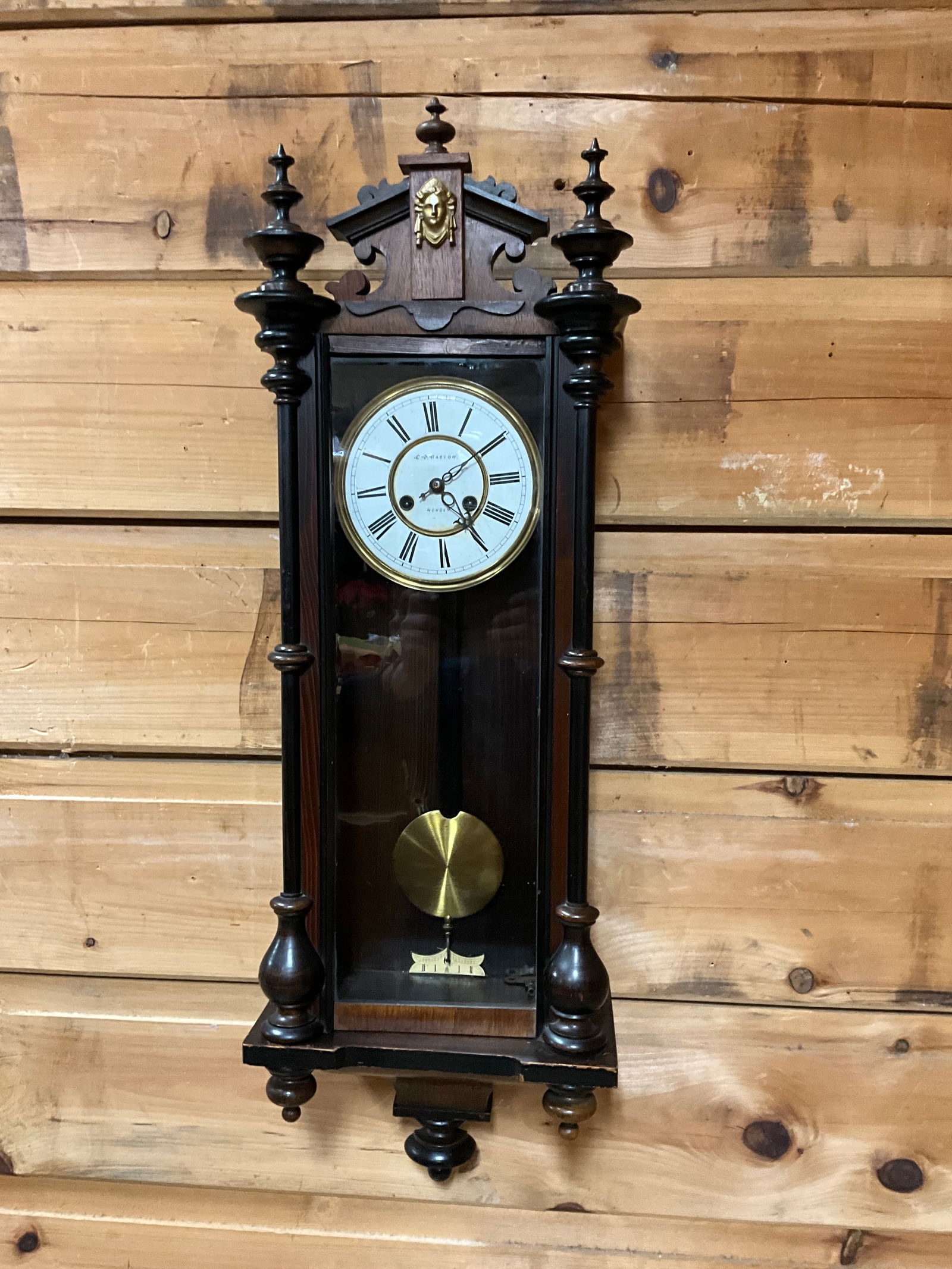 C.0. BASTO HOWDEN WALL CLOCK: SUPERB FINIALS. APPROX. 38.5"T X 12.5"W. RUNS AND STOPS.