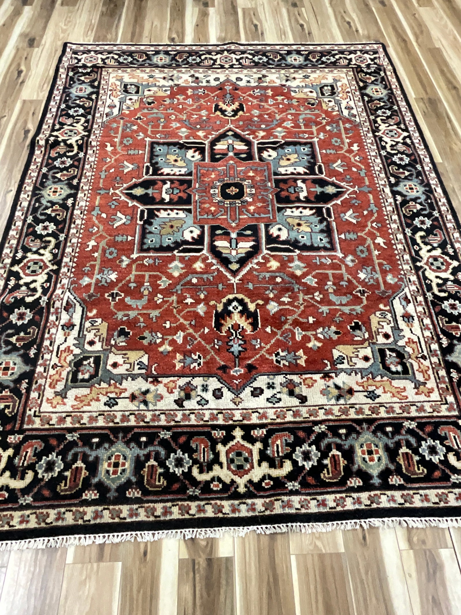 HERIZ HAND KNOTTED WOOL RUG: RUST, CREAM, BLACK, LIGHT BLUE, AND TAN. 8 X 10