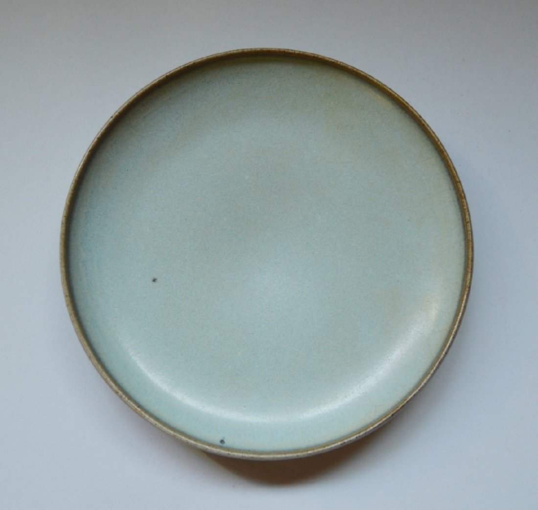 An Older Jun Kiln Large Dish: Light sky blue with orange peel glaze pooling in places, palm eyes, burnt brown foot ring, and rim turning dark mouse brown. 7 inches dia.