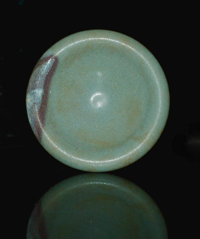 A Song Ming Dynasty Jun Yao Cover/Sauce Dish: Well potted with a purple splash on the edge to the turned down rim, fitting snug to the bowl below. Foot rim brown from the wood fire. Jun glaze a milky blue. 4 inches dia. Don't forget you must regi