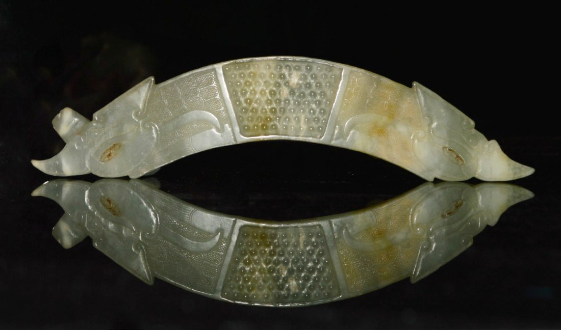 A Zhou Dynasty Dragon Headed Huang and Chi Lin: Dragon heads at either end with a rice pattern in between on the face and a chi lin pacing across the back. 5 inches across.