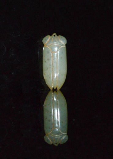 Zhou Dynasty Archaic Jade Cicada: Grayish white cicada with bulging eyes. 2 inches long