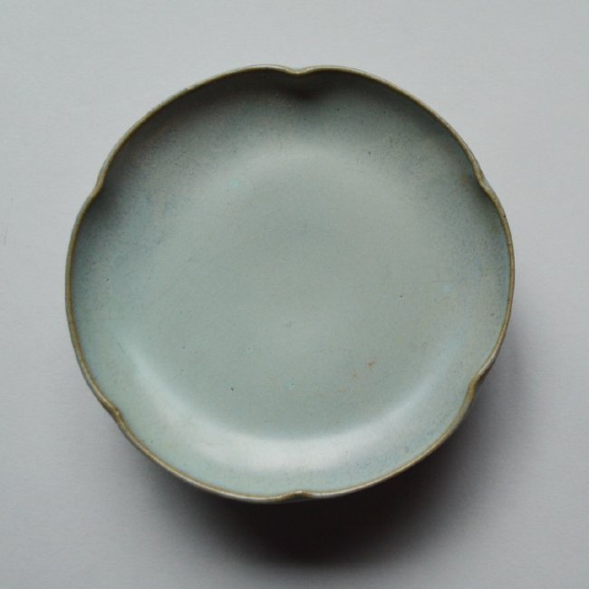 Song Ming Dynasty Pedestal Dish: A 6 foliate raised dish, blue green glaze all over, brown foot rim, foot interior glazed, mouse brown rim. 5 inches across.