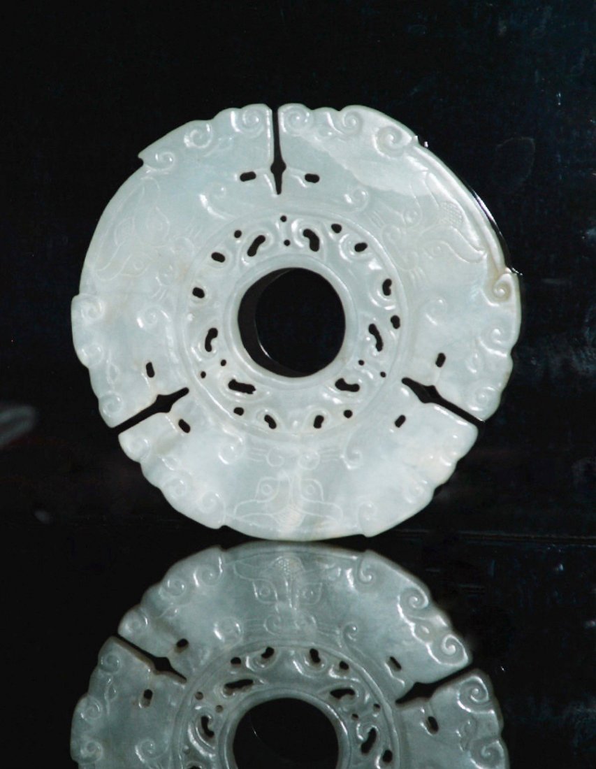 A Ming Qing Dynasty 6 Dragon Headed Bi: A unique mottle off white bi with 6 dragon heads spaced evenly around the ring, the central opening with open work designs of mythical animals banded on both sides, a tao tie mask between each of the 
