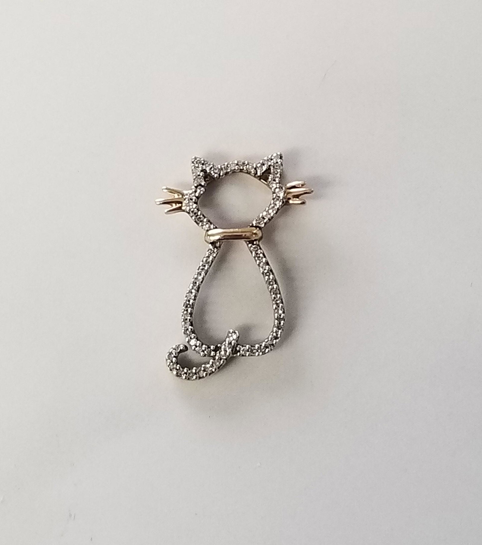 14K Gold Diamond Cat Pendant: This is an adorable 14k yellow gold pendant with a diamond lined cat outline design. It is 1 in x 1/2 in and weighs 1.7 grams.