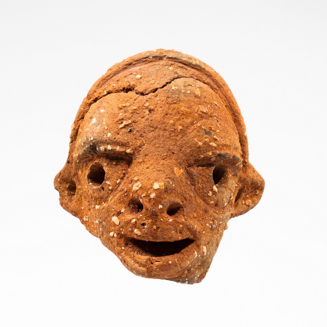 Nok young dignitary head: Orranged terra cota. Nok, Nigeria, 500 BC - AD 500. 10x9cm