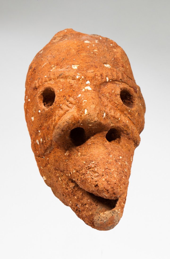 Nok head: Orranged terra cota. Nok, Nigeria, 500 BC - AD 500. 13x9cm