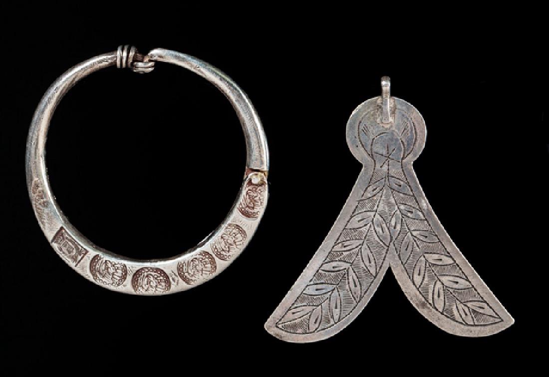 ear ornament and a talismanic pendant: Silver. Ethiopia and Tunisia. 6,5x6,5 - 7cm 44,5 - 12grams