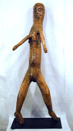 Raymond Coins Life-sized figure: Life Size Carved Figure. Carved wood, from a singlepiece of wood. Mounted on a sturdy metal stand. A Masterpiece by Coins. 20" w x 57" h. Provenance: Chuck and Jan Rosenak. This piece exhibited at the