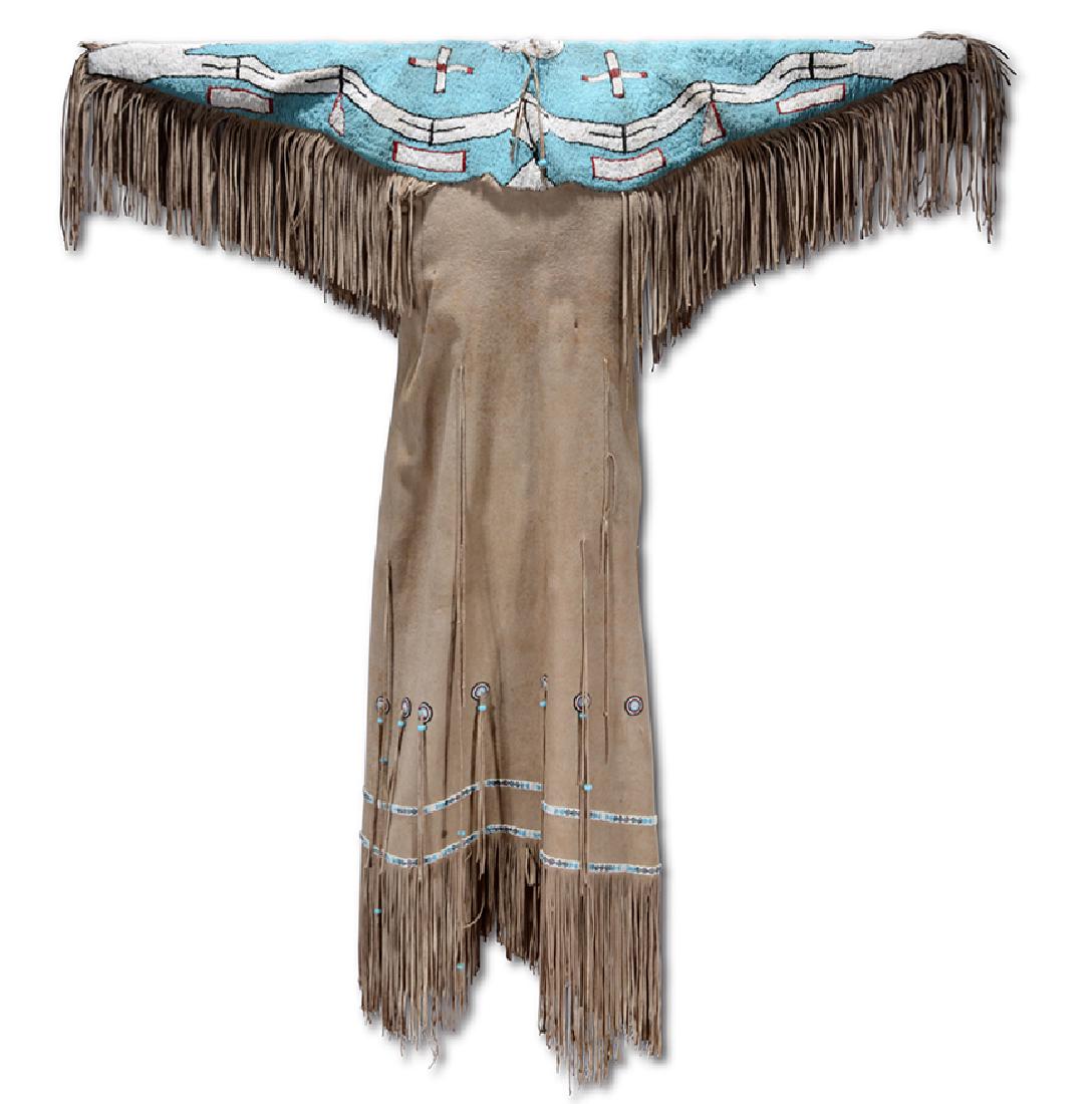 Native Am. Dbl-Sided Beaded Sky Blue Dance Dress.: Native American. Dbl-Sided Beaded Sky Blue Dance Dress. Heavily beaded shoulders and arms with fine beaded details along bottom of dress, on leather with cut tassles. Minor aging and foxing to leather