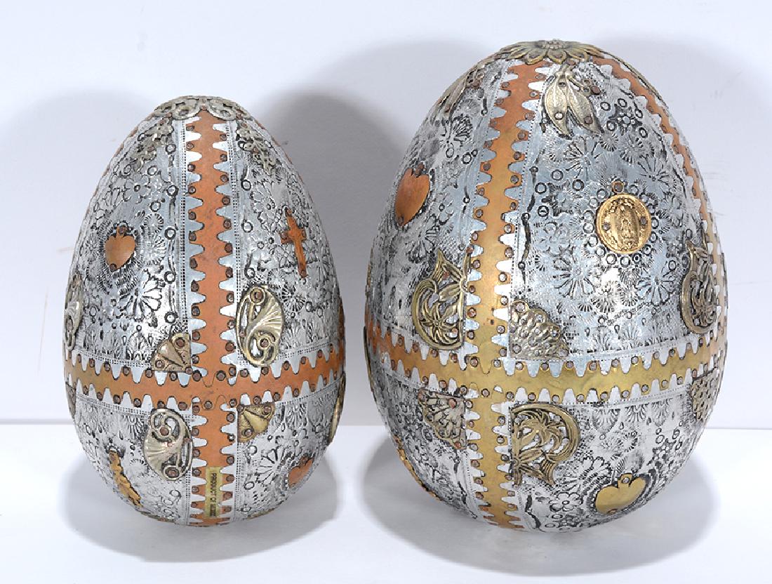 Pair of Decorated Catholic Eggs.: Pair of Decorated Catholic Eggs. Not signed. Carved wood eggs covered with brass and tin. Mini saints on both. Excellent condition. Largest is 8” h. Est. $200-300. Ship: $45
