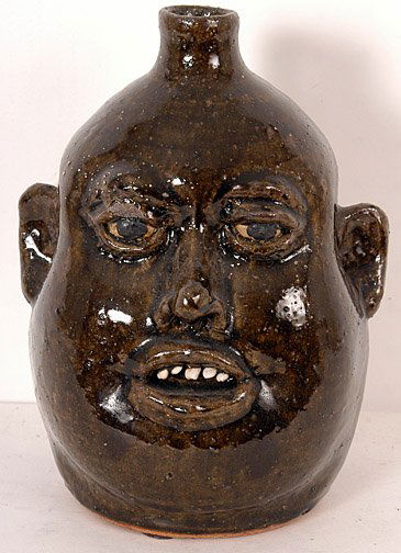 Lanier Meaders Face Jug with Sleepy Eyes.: Face Jug with Sleepy Eyes. 10" h. Chip on right eye and a small glaze flake. Est. $800 - $1,200. Ship: $35