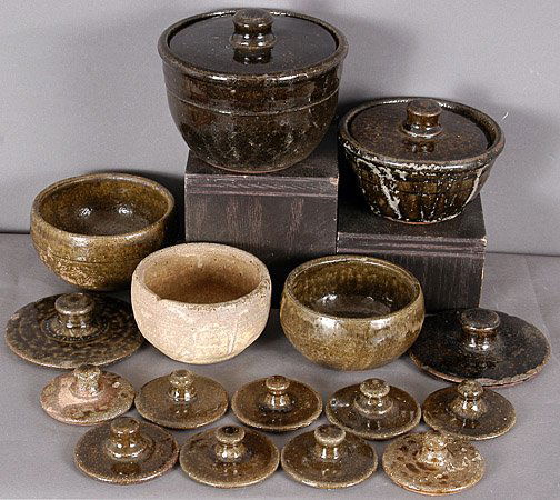 Lanier Meaders Miscellaneous Pottery Pieces: Mixed Lot of Miscellaneous Pottery Pieces. Includes 2 sugar bowls, 3 soup bowls, 11 misc. lids. The large bowl in center has a hairline crack halfway through. All other pieces are in good to excellent