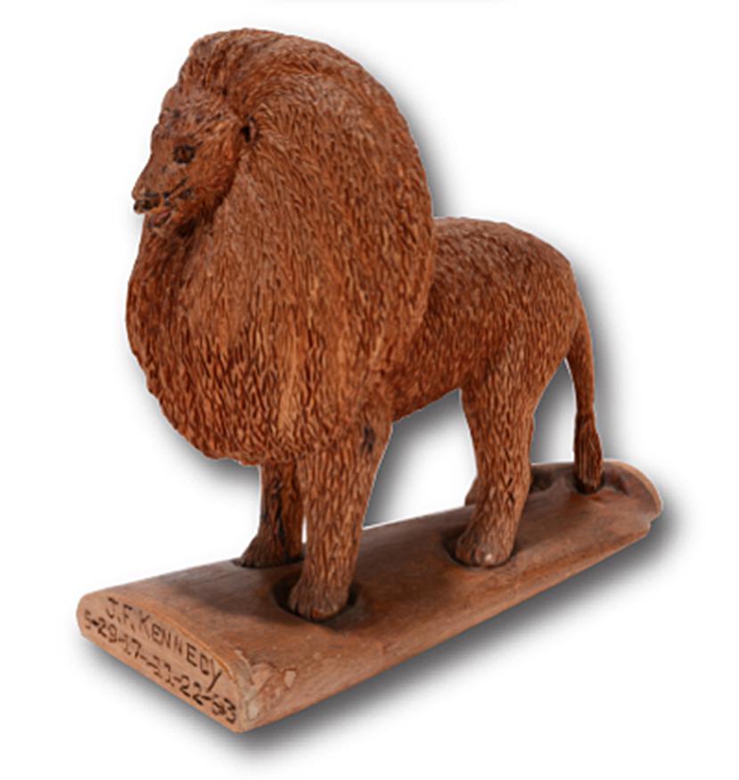 Ernest J. Smith. J.F. Kennedy Carving.: Ernest J. Smith. J.F. Kennedy 5-29-17 - 11-22-63. Carved wood lion on wooden rifle stock. 'J.F. Kennedy' and birth and death dates carved at front. Excellent condition. Weird and wonderful carving. 9.