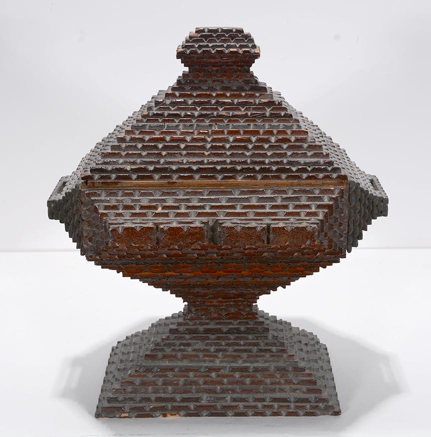 Tramp Art Pyramid Box On Pedestal.: Tramp Art Pyramid Box On Pedestal. c. 1930-40. Not signed. Chip-carved and stained wood. Excellent condition. 13” x 12” x 9”. Est. $300-500. Ship:$45