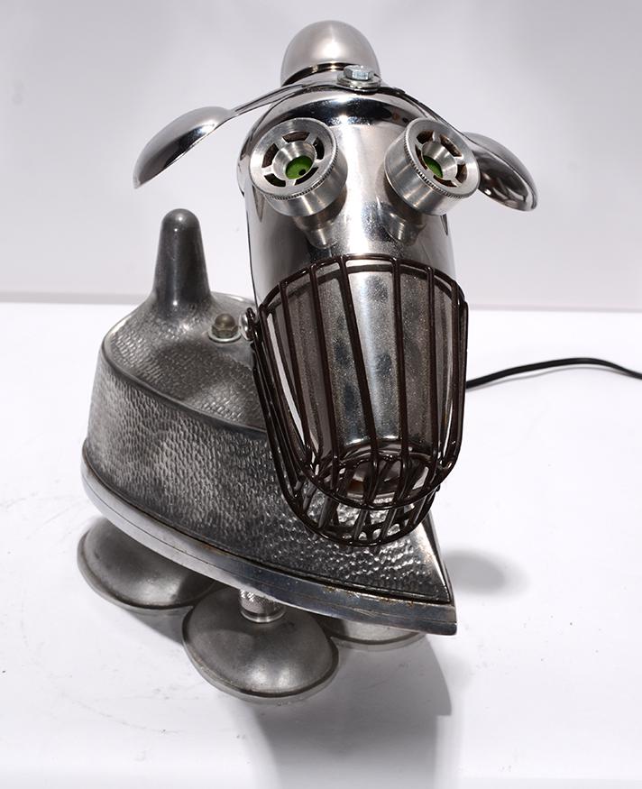 Jim Bauer. Dog With Muzzle.: Jim Bauer. Dog With Muzzle. 2014. Signed and dated. Electrified with working lights. Aluminum scrap pieces, found kitchenware construction. Excellent condition. 11” x 10” x 5”.