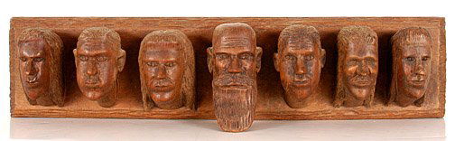 Clarence Stringfield, Seven Heads.: Carved wood. Signed, not dated. 22" w x 4.5" x 4". Est. $1,000-1,500. Ship: $35