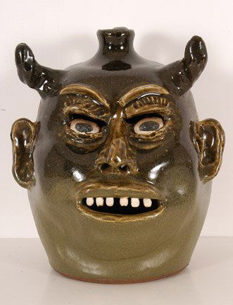 Lanier Meaders. Devil Jack O'Lantern.: c. late 1970's - early 1980's. Holes in back, mouth, eyes and ears allow the light to stream through. Clay teeth. Glossy glaze at top, matte glaze on bottom half. 9.75"h. Signed. Mint condition. A Slo