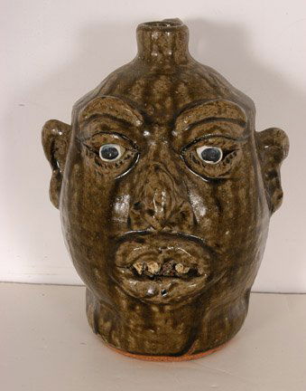 Lanier Meaders. Rock Tooth Face Jug.: Rare 1980's Rock Tooth Jug. c. mid 1980's. Nice tobacco-spit drip glaze. Small granite rocks in glaze. Signed. Cobalt blue eyes. 9.5"h. Mint condition. Est. $1,000-2,000. Ship: $45