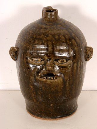 Reggie Meaders. 'Baby Face' Face Jug.: Tobacco-spit glaze. 8"h. Signed on bottom. Mint condition. Est. $200-400. Ship: $35