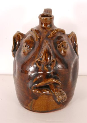 Robert Brown. Face Jug with Cigar.: 8" h. Mint condition. Est. $100-200. Ship: $35