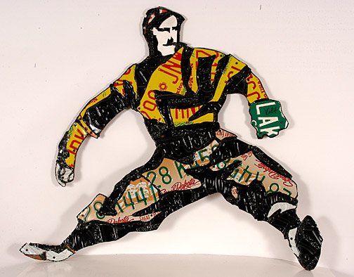 Michael Kalish. The Wind Up.: Cut and mounted license plate construction on wood. Signed on mitt. 40" x 35". Excellent condition. A large installation of Kalish's baseball players is permanently displayed at Atlanta's Turner Stadi