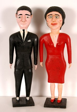 George Williams. Well Dressed Couple.: Carved and painted wood. Unsigned. Each is about 18.5" h. Bases are 4" x 4". Woman's foot has been re-attached, otherwise excellent condition. Est. $1,200-1,500. Ship: $45