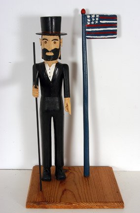 Ernest Patton. Abe Lincoln w Flag.: Carved and painted wood. 11" x 10" x 21.5". Excellent condition. Est. $800-1,200. Ship: $65