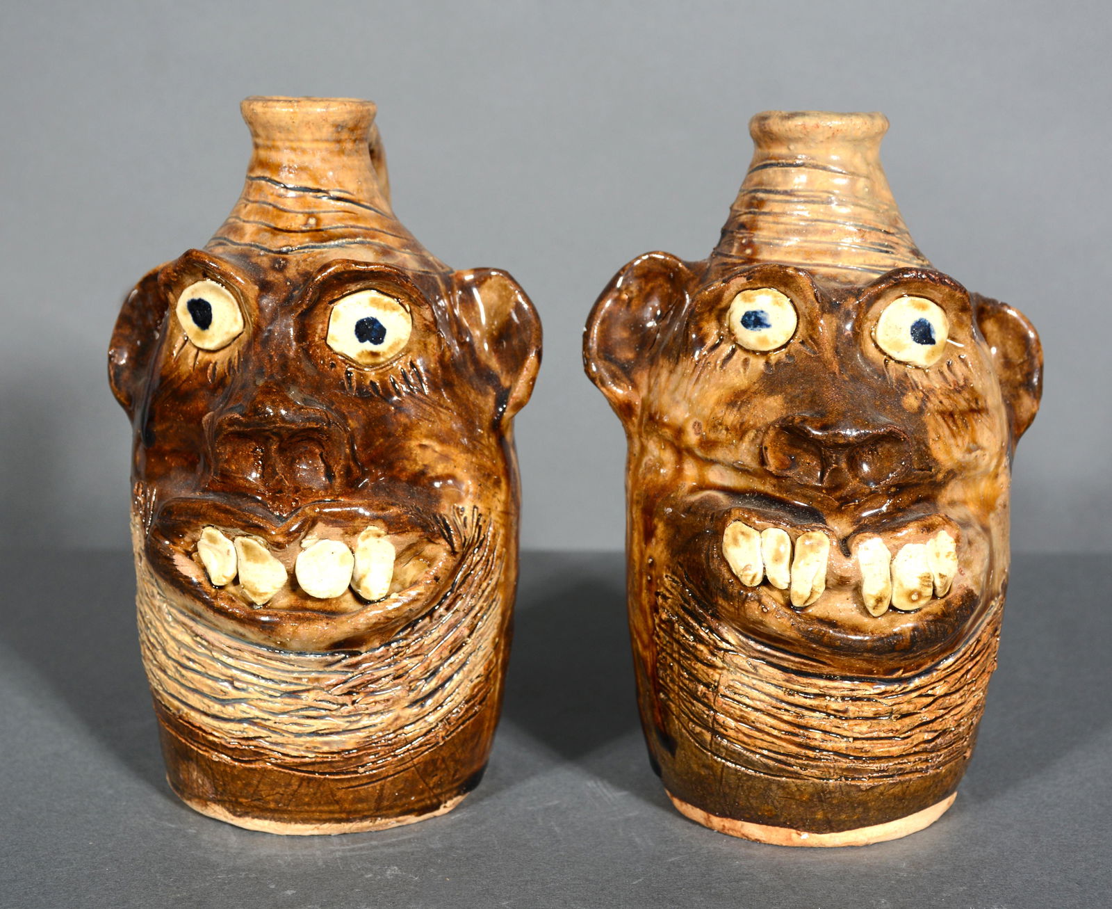 Marie Rogers. Pair of Smiling Face Jugs. (1 of 2)